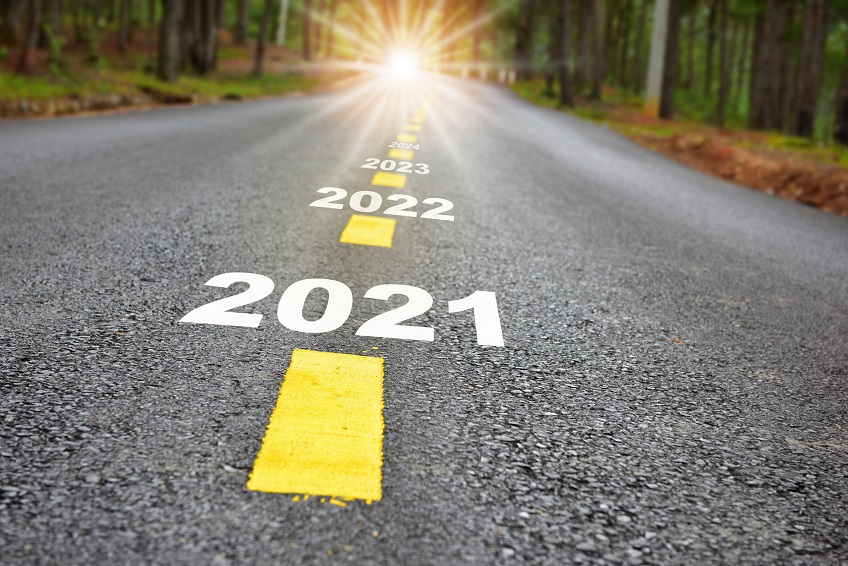 new year journey 2021 to 2024 on asphalt road surface with marking lines and sunlight